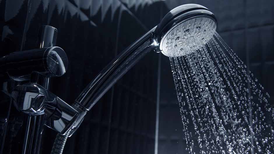 Sleek shower head with running water Sleek shower head with running water