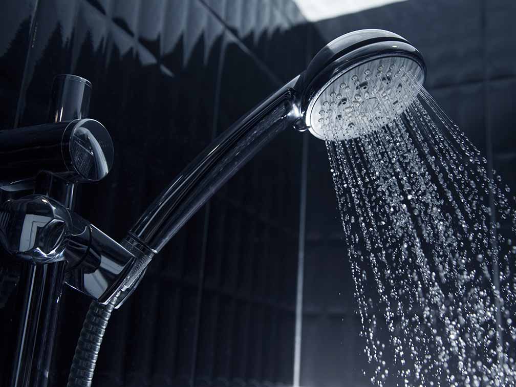 Sleek shower head with running water Sleek shower head with running water