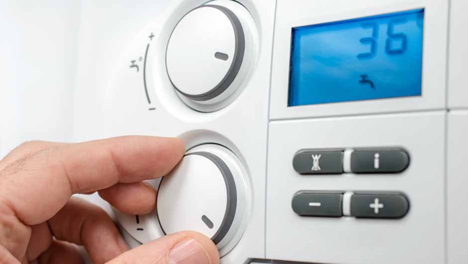 Person adjusting smart thermometer Person adjusting smart thermometer