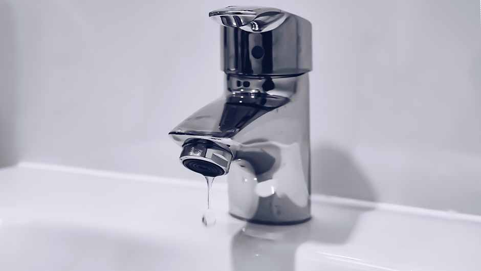 Modern silver tap dripping water Modern silver tap dripping water