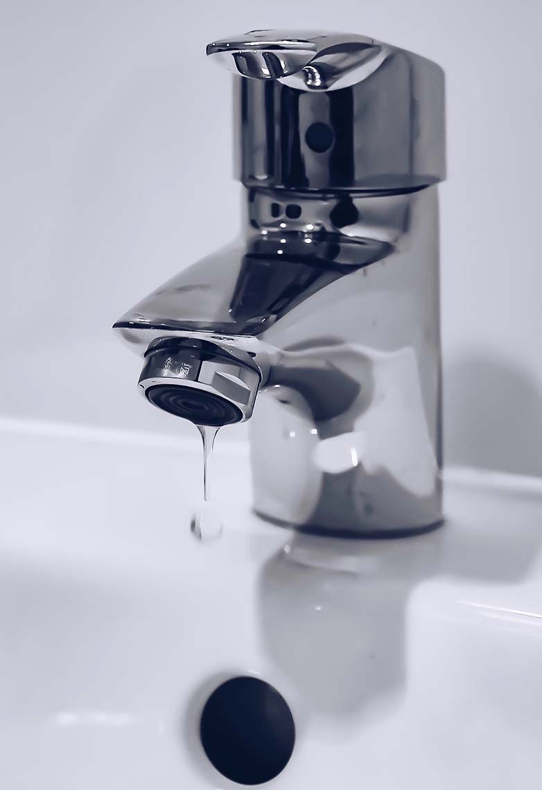 Modern silver tap dripping water Modern silver tap dripping water