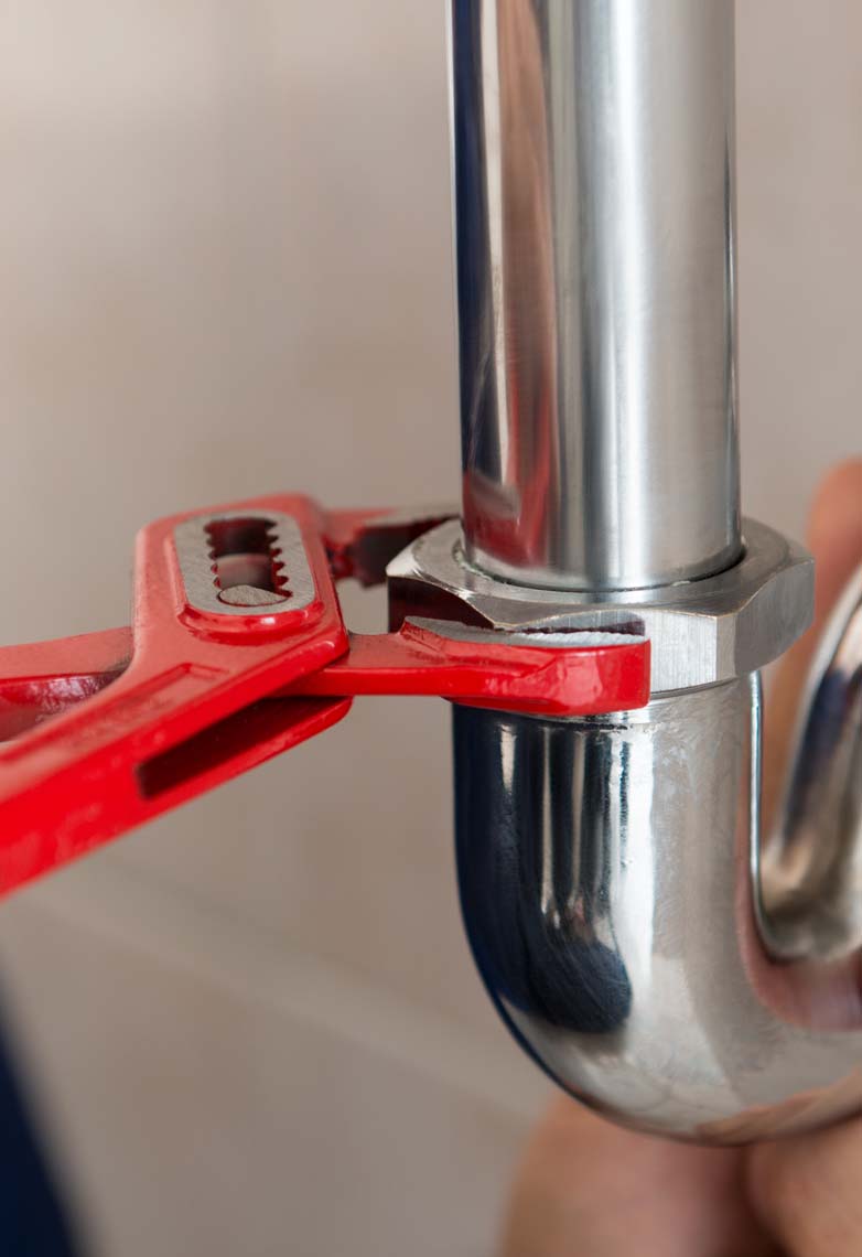 Plumber tightening silver pipe fitting Plumber tightening silver pipe fitting