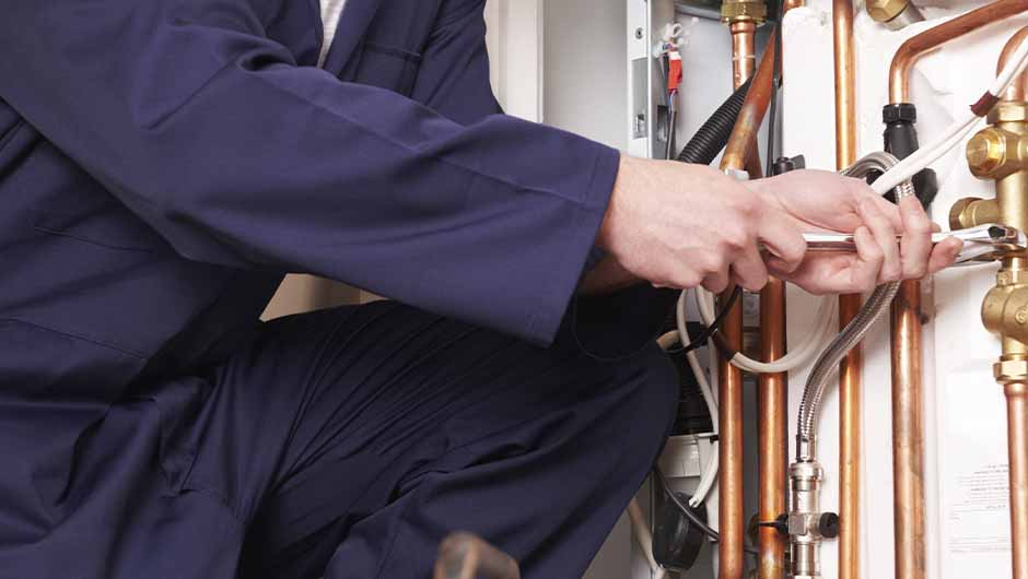 Plumber working on central heating system Plumber working on central heating system