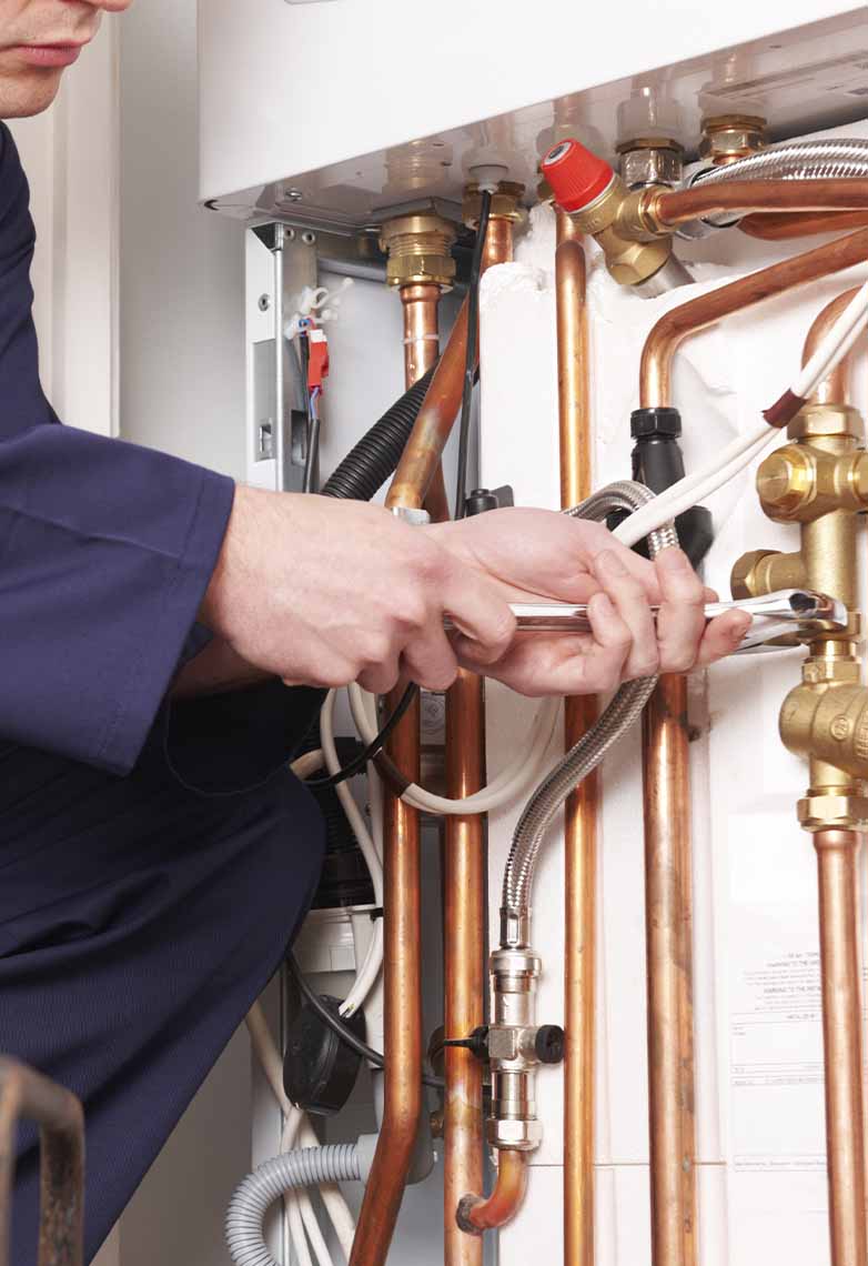 Plumber working on central heating system Plumber working on central heating system