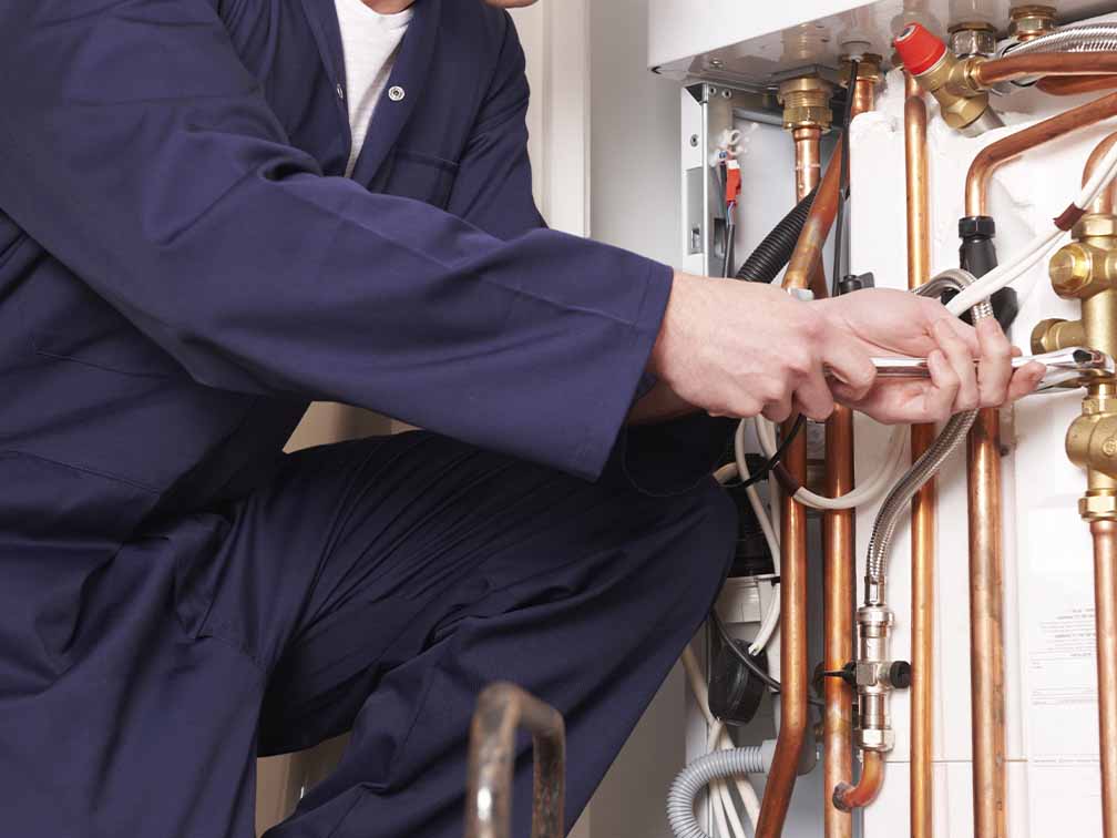 Plumber working on central heating system Plumber working on central heating system