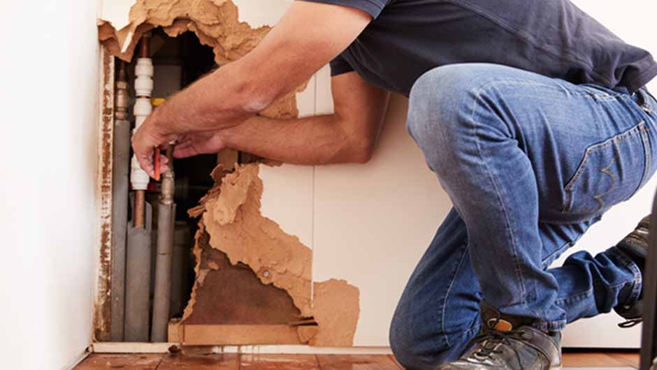 Emergency plumber working on burst pipe Emergency plumber working on burst pipe