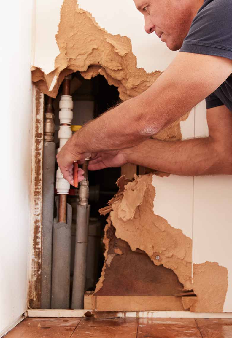 Emergency plumber working on burst pipe Emergency plumber working on burst pipe
