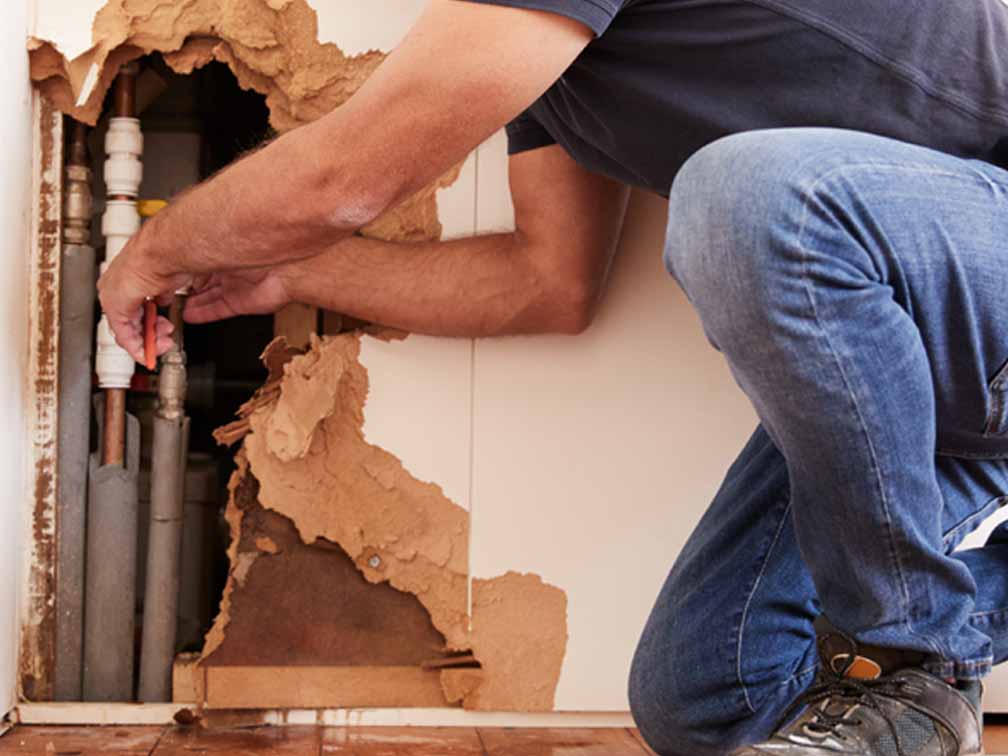 Emergency plumber working on burst pipe Emergency plumber working on burst pipe