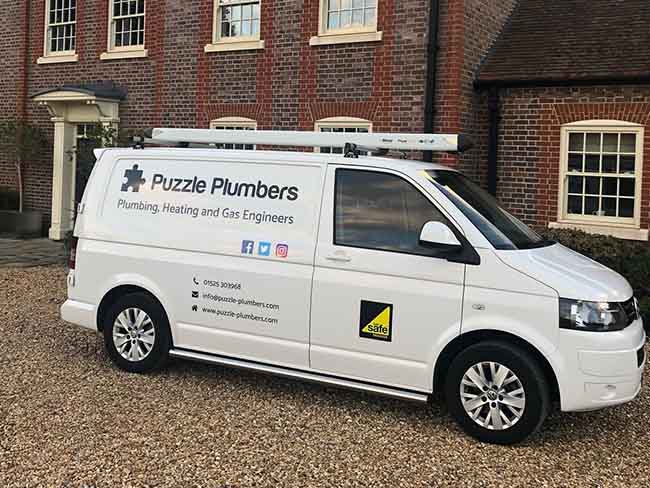 Side profile of a Puzzle Plumbers van Side profile of a Puzzle Plumbers van