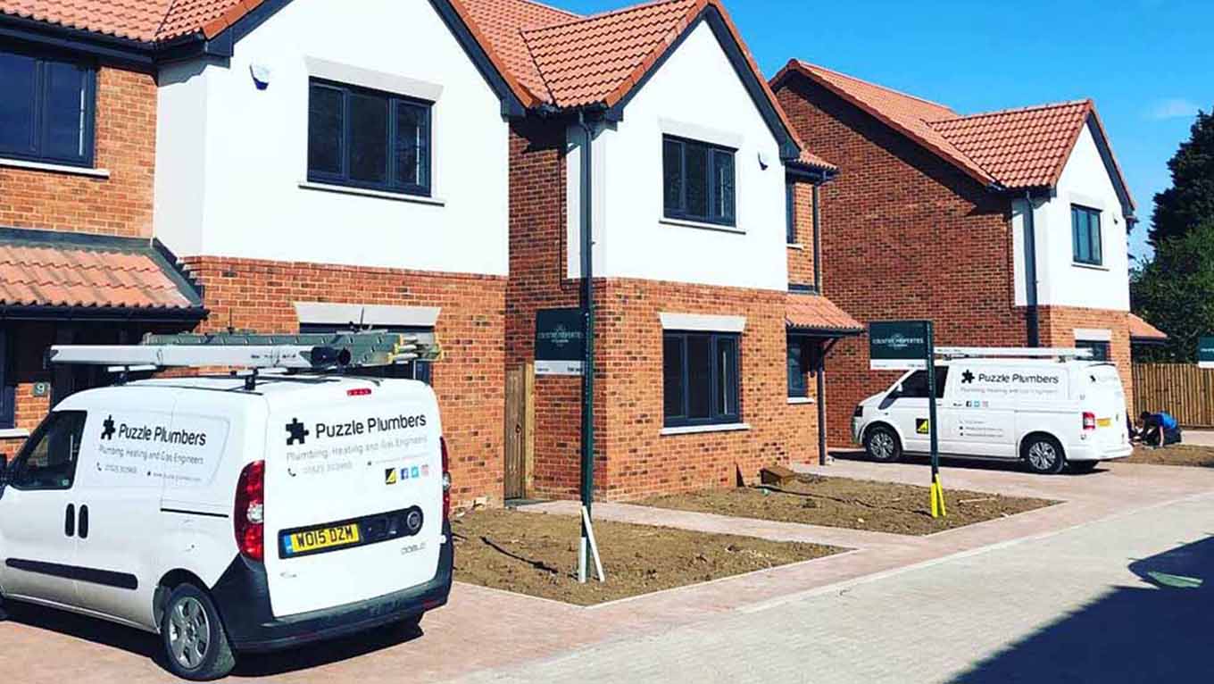 Puzzle Plumbers vans outside new builds Puzzle Plumbers vans outside new builds