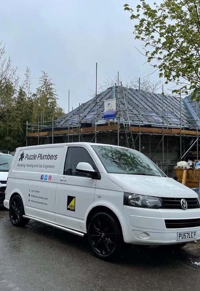 Puzzle Plumbers vans in front of new build house Puzzle Plumbers vans in front of new build house